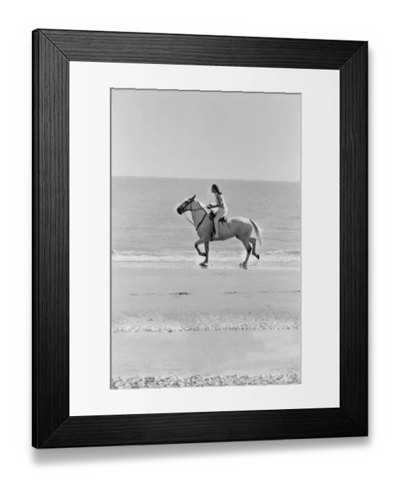 Framed Print : Diana Rigg, who plays Emma Peel, pictured riding a white horse across the beach at St Framed Print : Diana Rigg, who plays Emma Peel, pictured riding a white horse across the beach at St