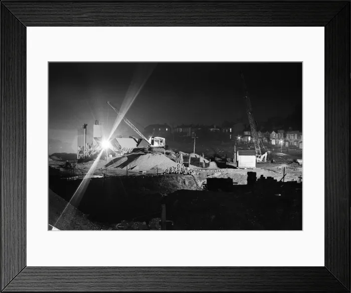 Framed Print : Silent cranes reach over what is usually a scene of intense activity by day - the site of Framed Print : Silent cranes reach over what is usually a scene of intense activity by day - the site of