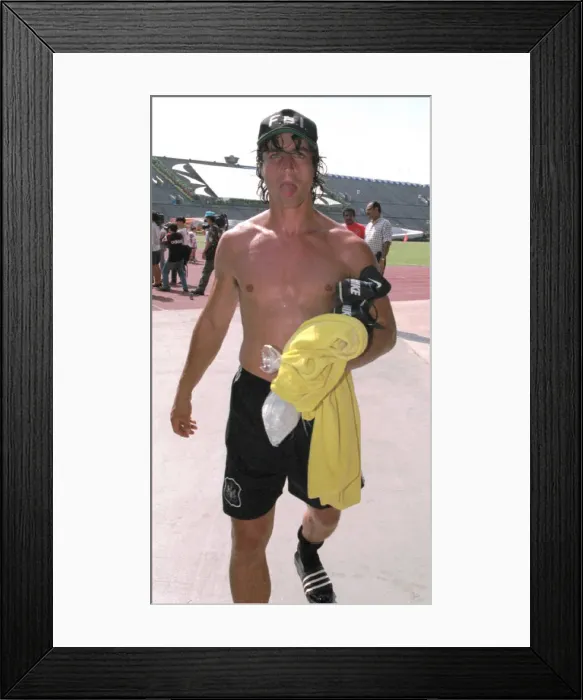 Framed Print : David Ginola pokes his tongue out after finishing a training session in Singapore