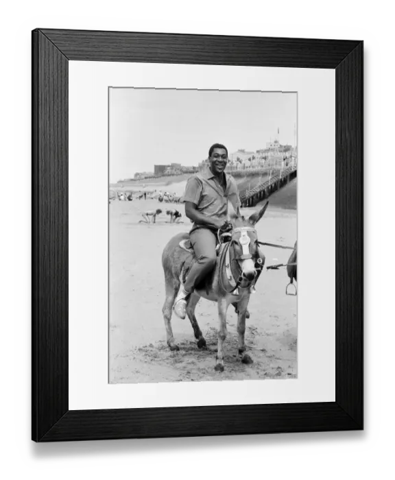 Framed Print : Lenny Henry riding a Donkey at Blackpool Beach, Lancashire. 15th July 1984