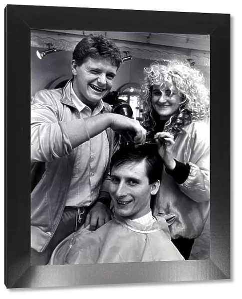 Newcastle United player Glenn Roeder pictured receiving a hair cut from team mate Paul