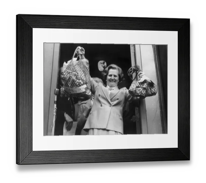 Framed Print : MARGARET THATCHER HOLDS ALOFT BAGS WITH SHOPPING BOUGHT IN 1974 AND 1979 TO ILLUSTRATE Framed Print : MARGARET THATCHER HOLDS ALOFT BAGS WITH SHOPPING BOUGHT IN 1974 AND 1979 TO ILLUSTRATE