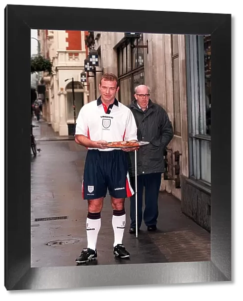 ALAN SHEARER MODELLING THE NEW 1997 ENGLAND HOME STRIP AND HOLDING A