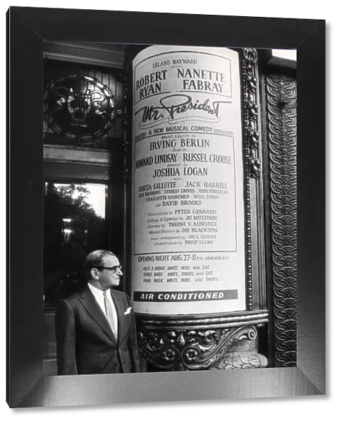 Irving Berlin stood by a poster for his new show, Mr President