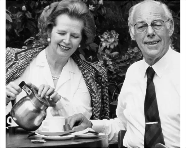 Margaret Thatcher and husband Denis drinking coffee in an outside cafe in a park - May