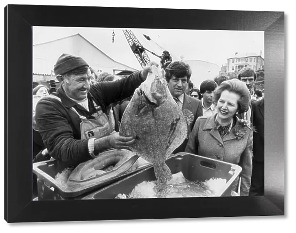 MARGARET THATCHER IS SHOWN A LARGE TURBOT BY LIFEBOAT MECHANIC EDDIE MURT IN PADSTOW