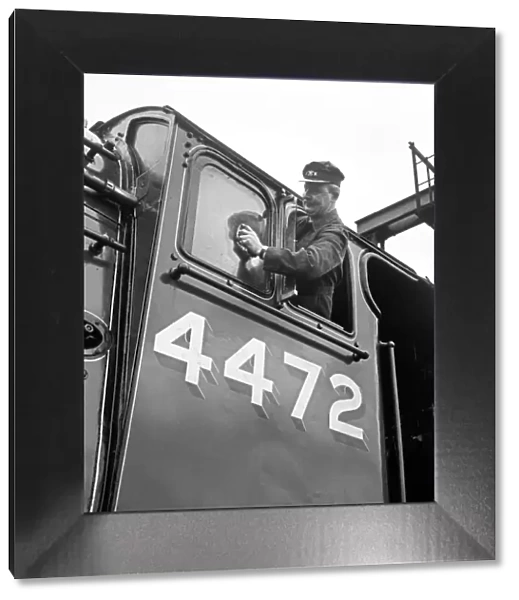 Mr Alan Pegler pictured cleaning The Flying Scotsman Engine window of the drivers cabin