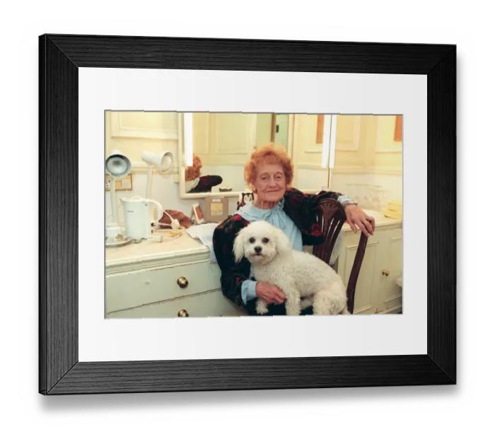 Framed Print : Emily Perry sitting in her dressing room with her dog, West End production of Dame Edna