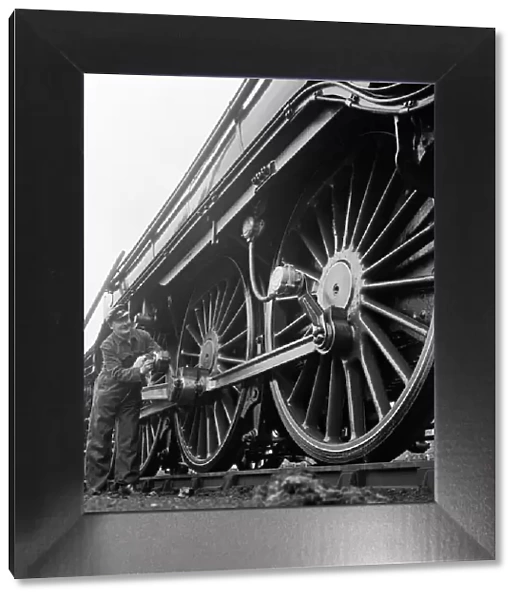 Mr Alan Pegler pictured cleaning the wheels of The Flying Scotsman engine