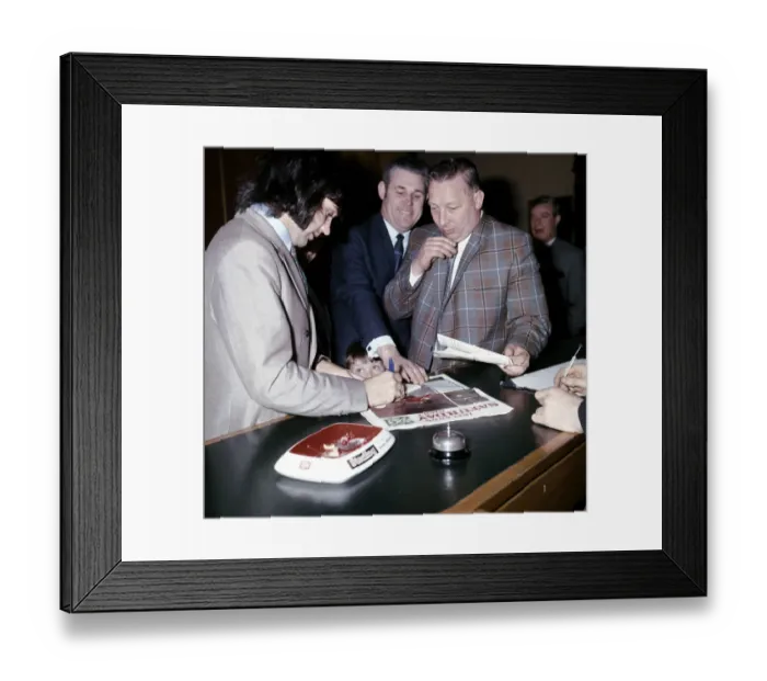 Framed Print : Manchester United and Northern Ireland footballer George Best signs autographs for a fan Framed Print : Manchester United and Northern Ireland footballer George Best signs autographs for a fan