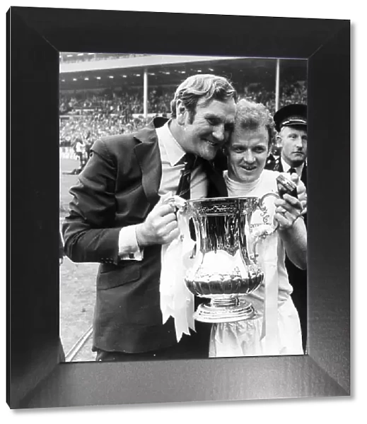 Leeds manager Don Revie with captain Billy Bremner hold the FA Cup trophy following their