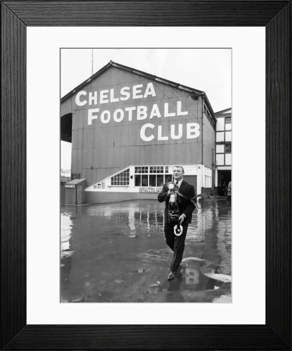 Framed Print : Manager Tommy Docherty leaving Chelsea Ground with a methuselah of champagne presented by