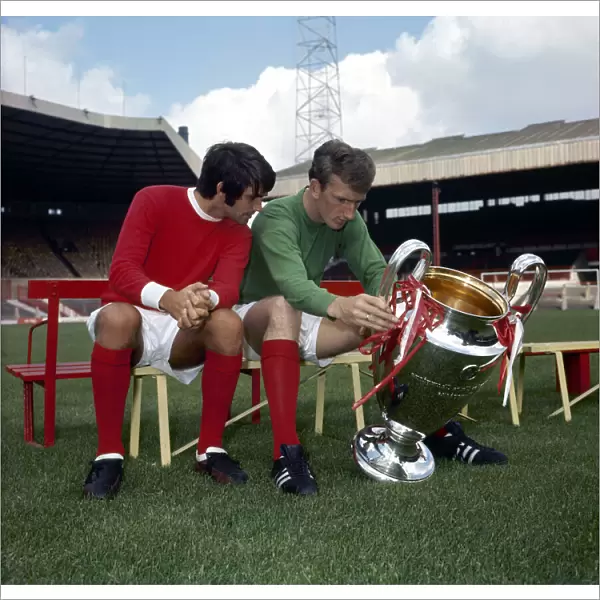 Manchester United footballers George Best and Alex Stepney admire the European Cup trophy