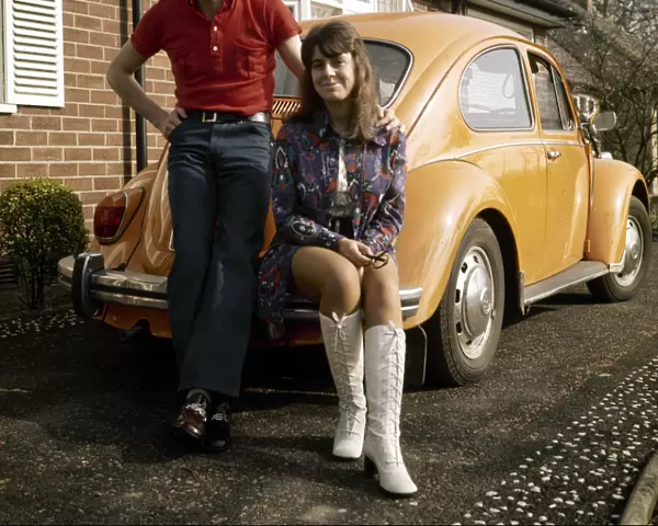 Liverpool footballer Steve Heighway and his wife Sue stand beside their Volkswagen Beetle