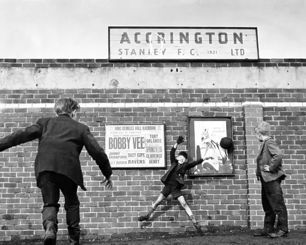 Accrington Stanley. No more football inside the ground so three youngsters play outside