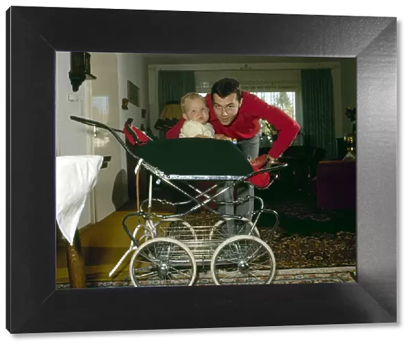 Captain of the West Germany football team Franz Beckenbauer pictured at home with his son