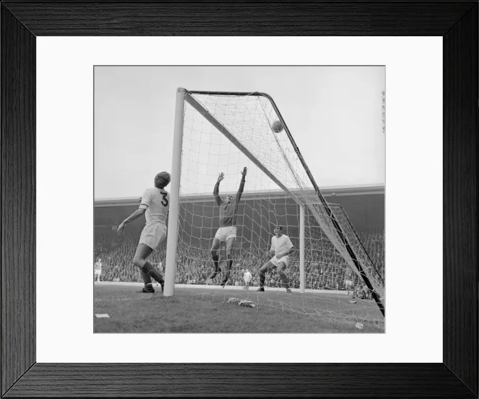 Framed Print : Arsenal defenders Billy McCullough and Don Howe assist goalkeeper Jim Furnell to put this