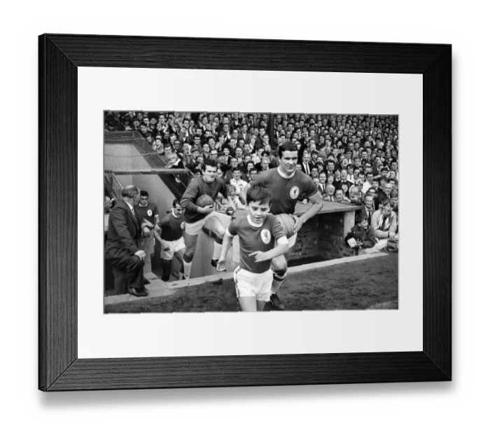 Framed Print : The Liverpool team run onto the pitch with their young mascot before the English league