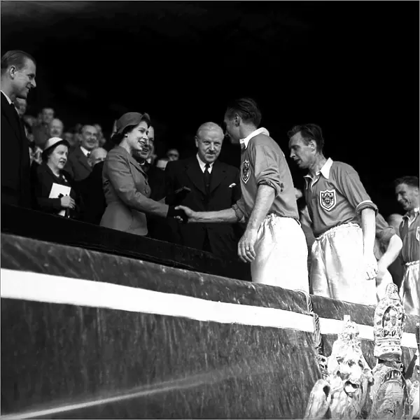 Blackpool footballer Stanley Matthews shakes hands with Her Majesty Queen Elizabeth II
