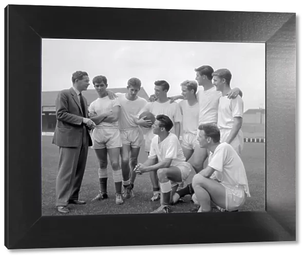 Peterborough team listen to their manager before a training session August 1960