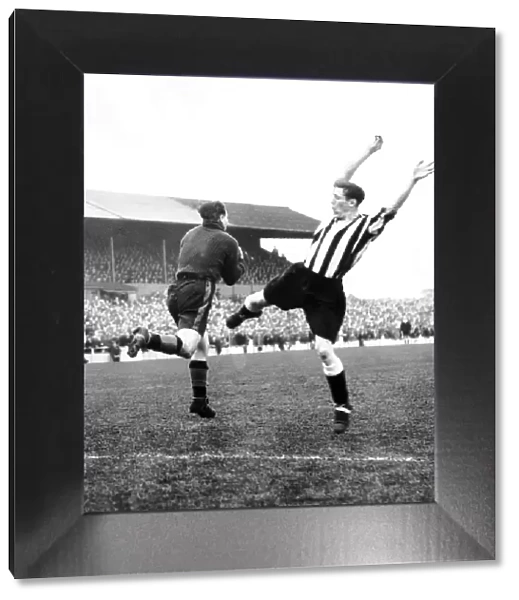 Len Shackleton of Newcastle (right) is beaten to the ball by Doncaster goalkeeper