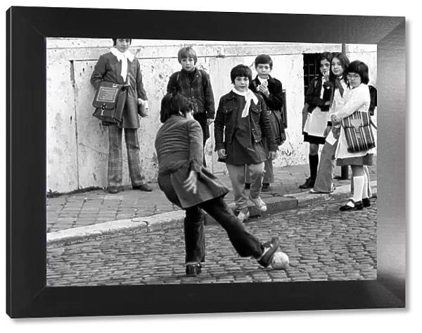 Children playing football on the streets in a poor suburb on the outskirts of Rome