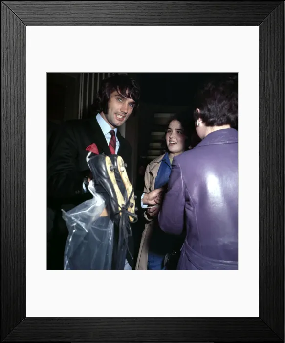 Framed Print : Manchester United footballer George Best carrying his boots September 1969