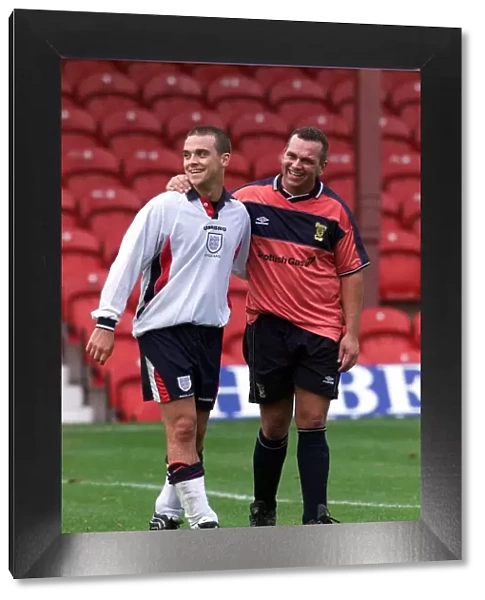 Robbie Williams playing football November 1999 wearing a England kit for the first half