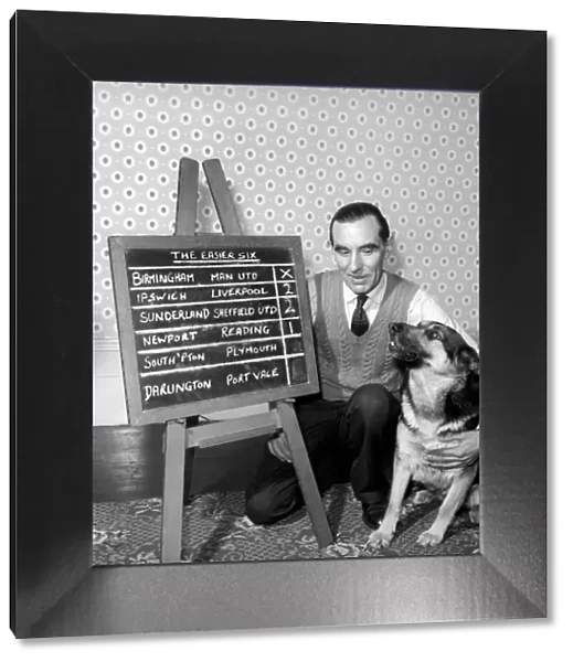 Bob Smith and his alsatian dog who helps him pick his football pools. 1957