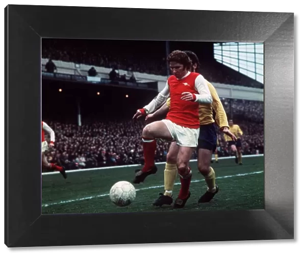Alan Ball of Arsenal holds in control of the ball during a league match at Highbury