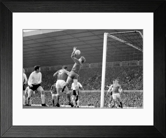 Framed Print : Sunderlands Jim Montgomery leaps high to hold this ball during a Manchester United raid