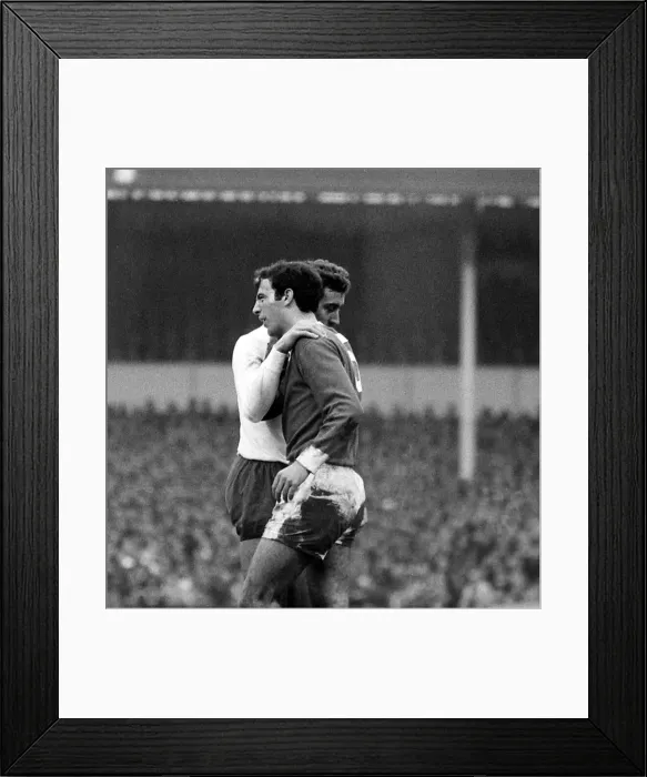 Framed Print : Martin Chivers of Tottenham Hotspur puts his arm round David Sadler of Manchester United Framed Print : Martin Chivers of Tottenham Hotspur puts his arm round David Sadler of Manchester United