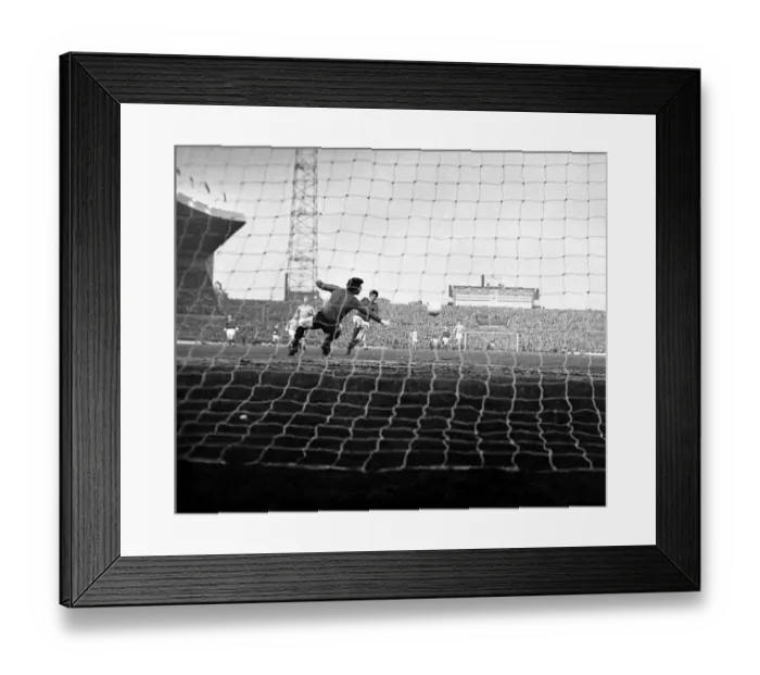 Framed Print : Manchester United star George Best scores past Manchester City goalkeeper Ken Mulhearn Framed Print : Manchester United star George Best scores past Manchester City goalkeeper Ken Mulhearn