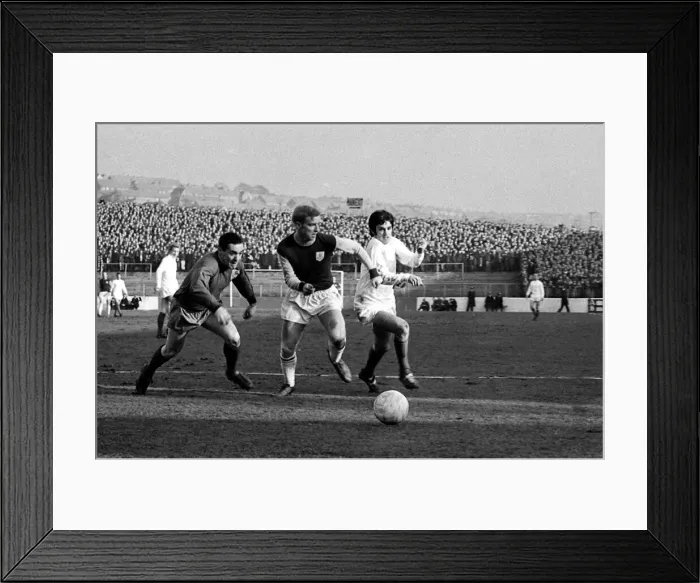 Framed Print : Manchester United star George Best dashes for the ball with Burnley goalkeeper Thomson Framed Print : Manchester United star George Best dashes for the ball with Burnley goalkeeper Thomson