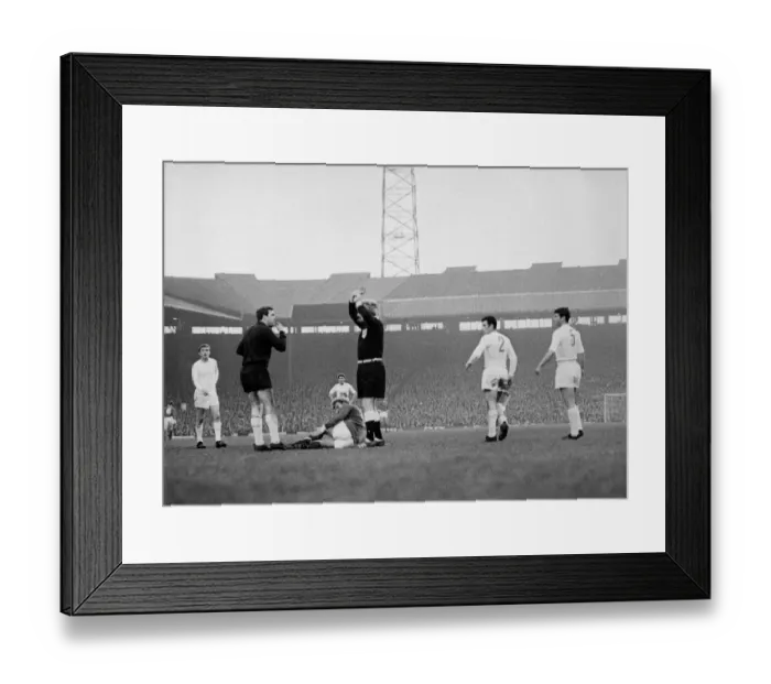 Framed Print : Manchester Uniteds Denis Law lies injured on the ground against Real Madrid in Framed Print : Manchester Uniteds Denis Law lies injured on the ground against Real Madrid in