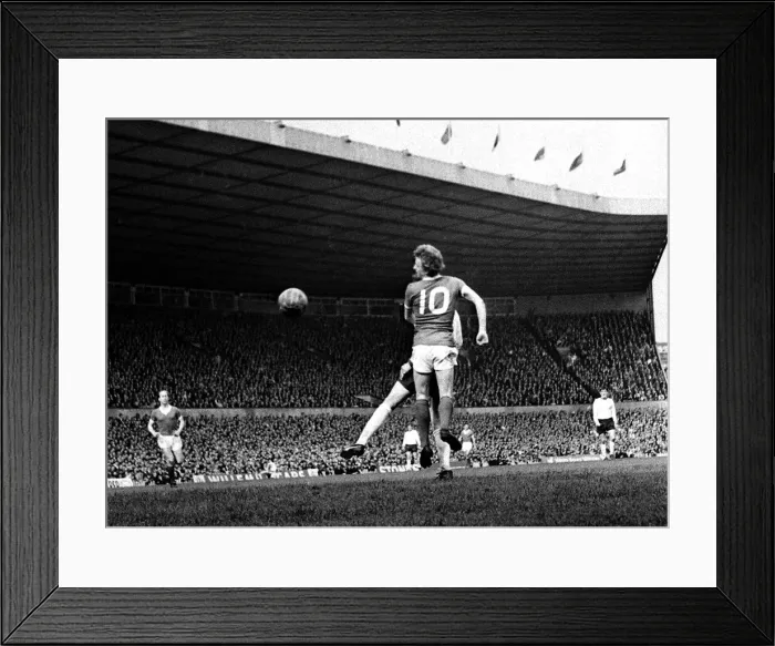Framed Print : Denis Law of Manchester United jumping up for the hogh ball during his side Framed Print : Denis Law of Manchester United jumping up for the hogh ball during his side