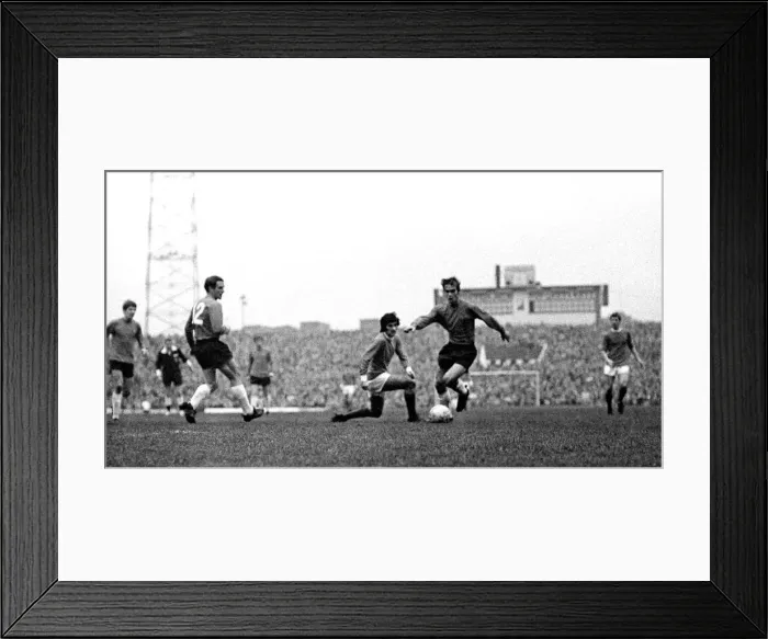 Framed Print : Manchester Uniteds George Best challenges an Ipswich player for the ball during Framed Print : Manchester Uniteds George Best challenges an Ipswich player for the ball during