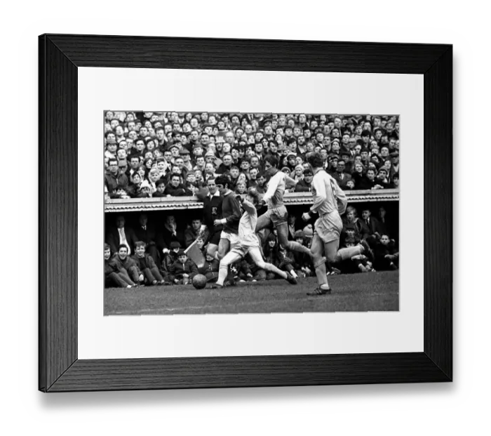 Framed Print : George Best on the wing for Manchester United challenged by three defenders during