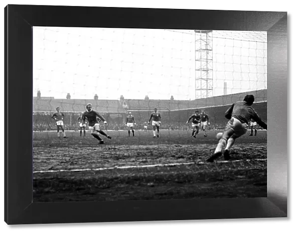 Denis Law scores for Manchester United from the penalty spot during the match against