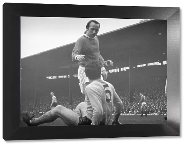 Manchester Uniteds Nobby Stiles helps up an opponent during the league match against