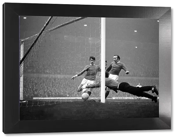 Manchester United goalkeeper Alex Stepney dives to pounce on the ball