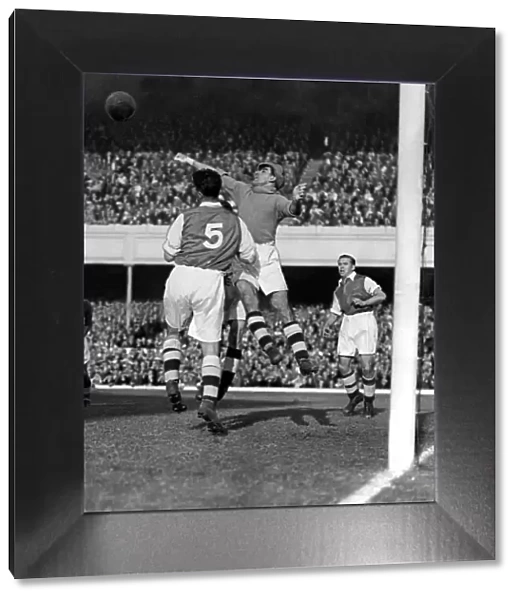 Sport - Football - Arsenal - George Swindin, the Arsenal goalkeeper punches the ball