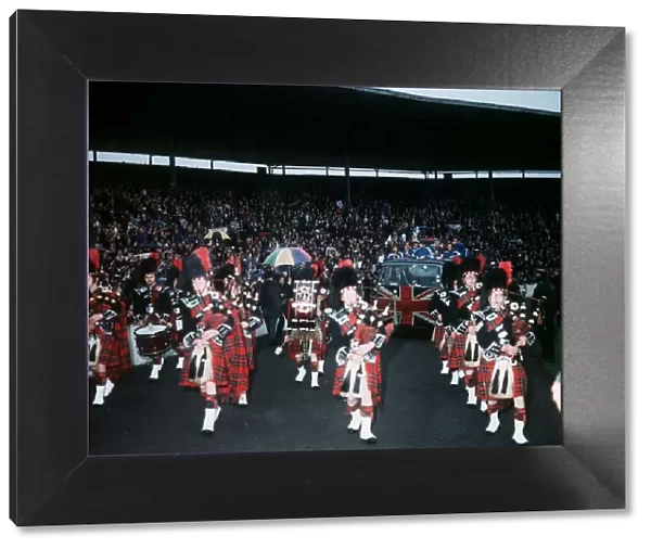 A Pipe band leads Rangers players in a parade around Ibrox Park on lorry with