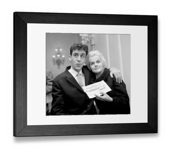 Framed Print : Pools winner Vivienne Nicholson smiles with her husband Keith Howard Nicholson holding a