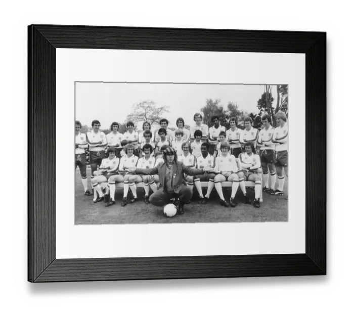 Framed Print : Elton John superstar and members of the England football team pose with schoolchildren in