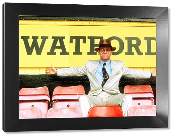Elton John on rejoining Watford football club as director sitting in front of sign white