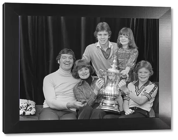 Laurie McMenemy with his wife and children holding the FA Cup at their home 14  /  2  /  77