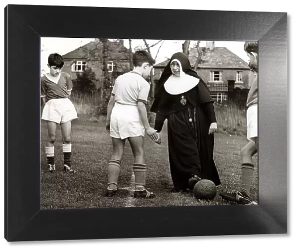 Sister Gabriel explains the art of trapping the ball to a young footballer of the St