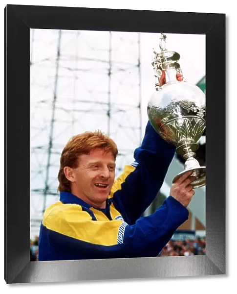 Gordon Strachan of Leeds United holds up the First division league championship trophy