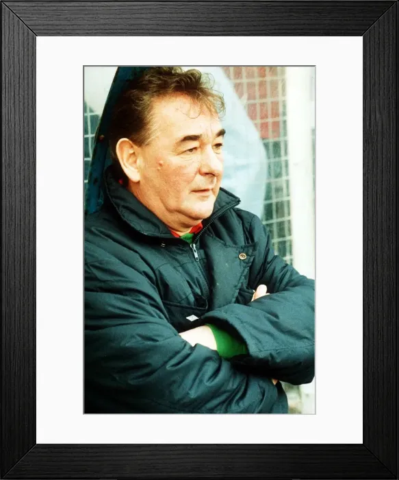 Framed Print : Brian Clough football manager sitting on team bench in football jacket with arms folded Framed Print : Brian Clough football manager sitting on team bench in football jacket with arms folded